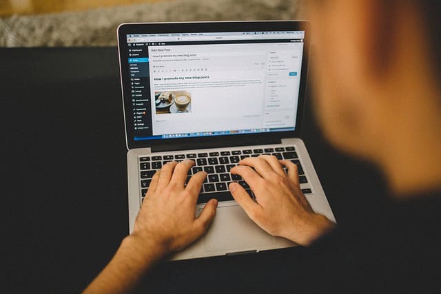 man typing on his computer