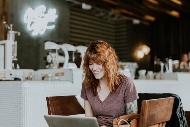 lady laughing and working on her computer