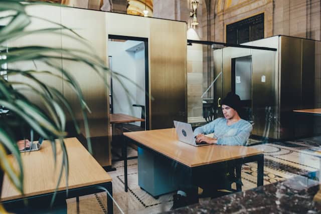 guy on his computer in an open space