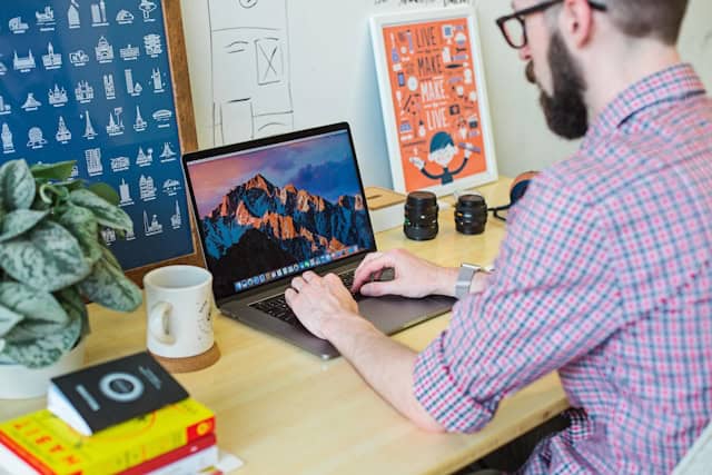 guy working on his computer in a desk