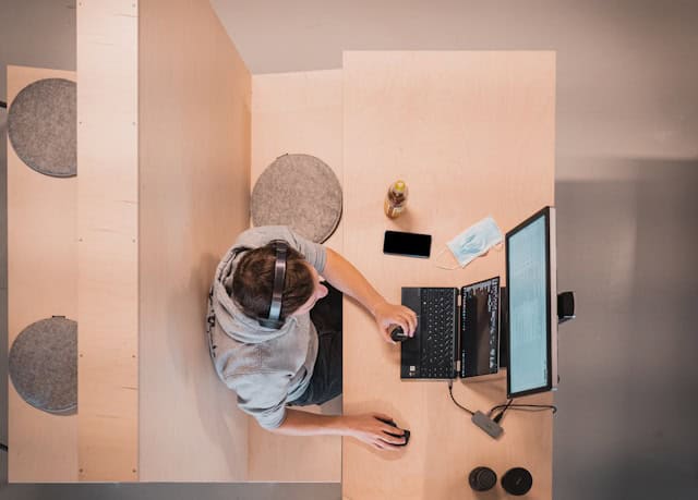 person working on their computer with a view from the top