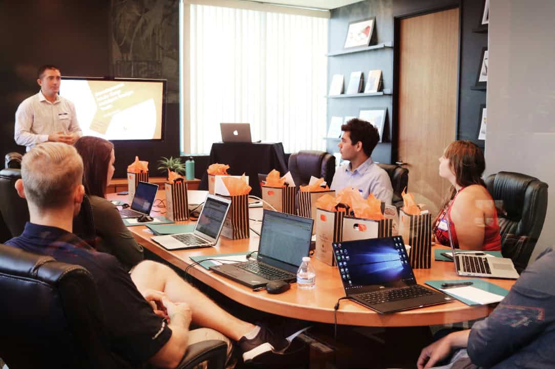 coworkers around a table during a presentation